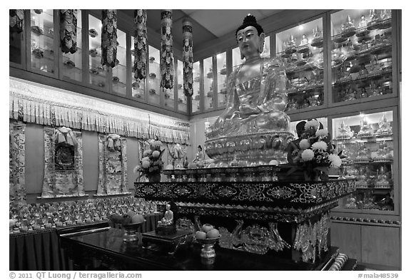 Buddha image inside Yellow Hat Buddhist temple. George Town, Penang, Malaysia (black and white)