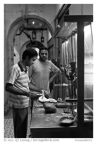 Man preparing nan bread in arcade. George Town, Penang, Malaysia (black and white)