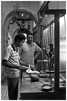 Man preparing nan bread in arcade. George Town, Penang, Malaysia (black and white)
