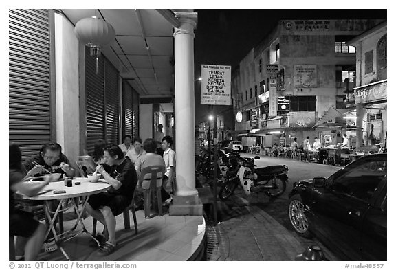Eating on the street at night. George Town, Penang, Malaysia (black and white)