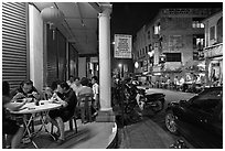 Eating on the street at night. George Town, Penang, Malaysia (black and white)
