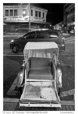 Rickshaw and auto at night. George Town, Penang, Malaysia