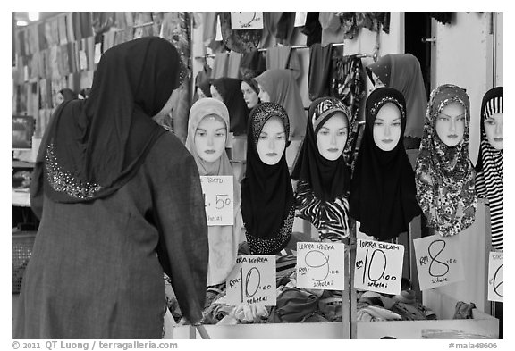 Woman in apparel store with islamic headscarves for sale. Kuala Lumpur, Malaysia