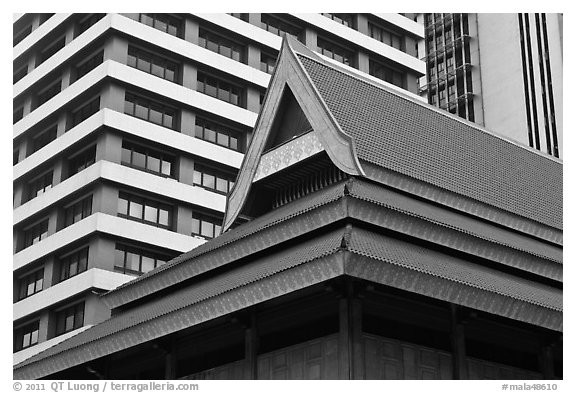 Roof of traditional tek house and modern buildings. Kuala Lumpur, Malaysia (black and white)