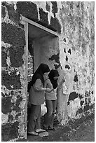 Malay girls exit on St Paul church doorway. Malacca City, Malaysia ( black and white)