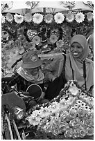 Mother and child riding decorated trishaw. Malacca City, Malaysia (black and white)