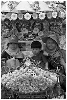 Malay children riding on trishaw. Malacca City, Malaysia (black and white)