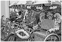 Trishaws decorated with plastic flowers. Malacca City, Malaysia (black and white)