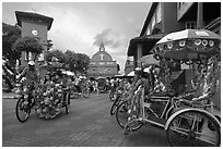 Trishaws, clock tower, and church. Malacca City, Malaysia (black and white)