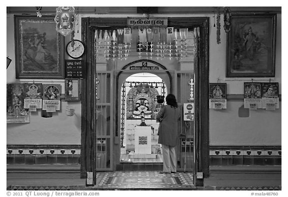 Women worshipping Hindu deity Vinayaga, Sri Poyyatha Vinayagar Moorthi. Malacca City, Malaysia (black and white)