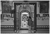 Women worshipping Hindu deity Vinayaga, Sri Poyyatha Vinayagar Moorthi. Malacca City, Malaysia (black and white)