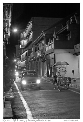 Car and bicycle rickshaw at night. Malacca City, Malaysia (black and white)