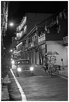 Car and bicycle rickshaw at night. Malacca City, Malaysia (black and white)