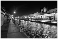 Melaka River at night with St Peters Church towers. Malacca City, Malaysia (black and white)