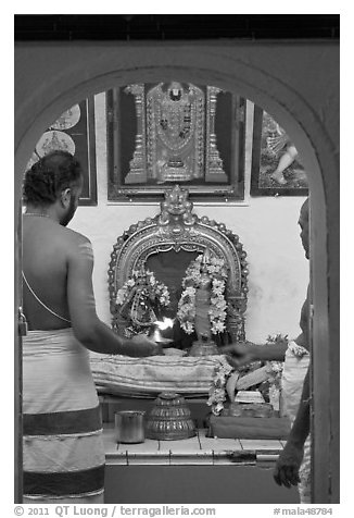 Holy men lighting fire, Sri Poyyatha Vinayagar Moorthi Temple. Malacca City, Malaysia (black and white)