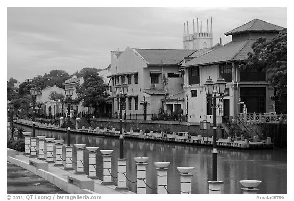 Lamps, riverside houses and St Peters Church towers. Malacca City, Malaysia (black and white)