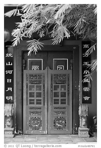 Weathered door with chinese signs and lanterns. Malacca City, Malaysia (black and white)