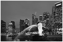 Merlion fountain and skyline at dusk. Singapore (black and white)