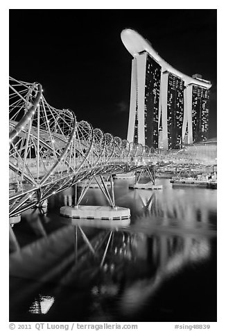 Helix Bridge and Marina Bay Sands hotel at night. Singapore (black and white)