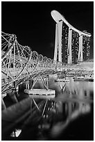 Helix Bridge and Marina Bay Sands hotel at night. Singapore (black and white)