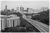 Freeway bordered by parklands and high rises. Singapore (black and white)