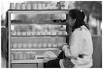 Woman selling dairy desserts on the street. Guadalajara, Jalisco, Mexico (black and white)
