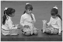 Three little girls in school uniform eating snack. Guadalajara, Jalisco, Mexico ( black and white)