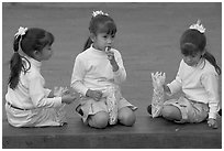 Three little girls in school uniform eating snack. Guadalajara, Jalisco, Mexico (black and white)