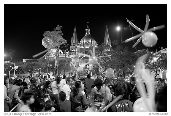 Children playing with ballons on Plaza de la Liberacion by night. Guadalajara, Jalisco, Mexico