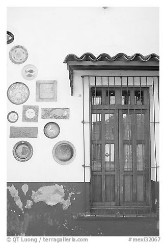Wall decorated with colorful ceramic pieces, Tlaquepaque. Jalisco, Mexico (black and white)