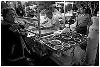 Woman eating by a street food stand , Tlaquepaque. Jalisco, Mexico (black and white)