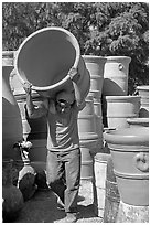 Man carrying a heavy pot, Tonala. Jalisco, Mexico (black and white)
