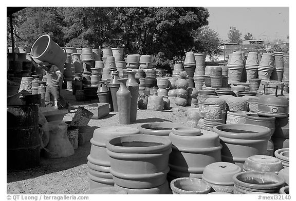 Pots for sale, with a man loading in the background, Tonala. Jalisco, Mexico