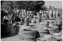 Pots for sale, with a man loading in the background, Tonala. Jalisco, Mexico (black and white)