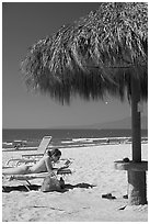 Woman in swimsuit reading on beach chair, Nuevo Vallarta, Nayarit. Jalisco, Mexico (black and white)