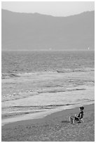 Woman sitting on the beach looking at the sunset, Nuevo Vallarta, Nayarit. Jalisco, Mexico (black and white)