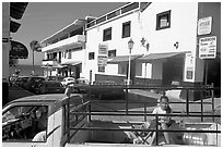 Girl riding in the back of pick-up truck in a street close to ocean, Puerto Vallarta, Jalisco. Jalisco, Mexico ( black and white)