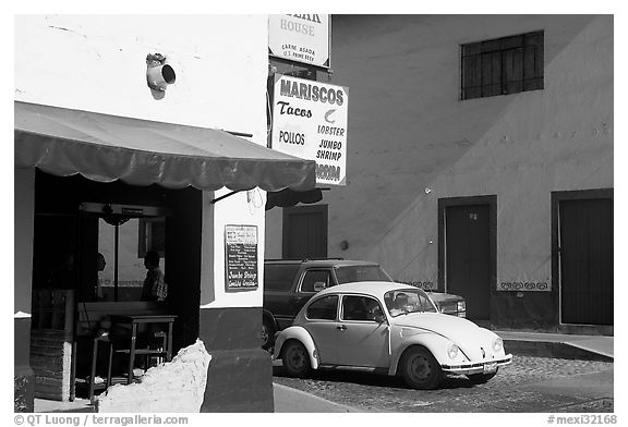 Restaurant at a street corner and Mexico made Wolskwagen bug, Puerto Vallarta, Jalisco. Jalisco, Mexico (black and white)