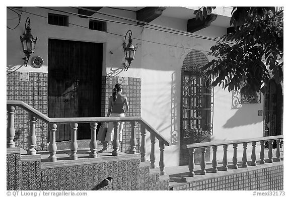 Woman waiting at the door of a house, Puerto Vallarta, Jalisco. Jalisco, Mexico