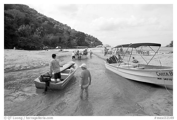 Boats moving from lagoon to ocean via small channel,  Boca de Tomatlan, Jalisco. Jalisco, Mexico