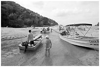 Boats moving from lagoon to ocean via small channel,  Boca de Tomatlan, Jalisco. Jalisco, Mexico (black and white)