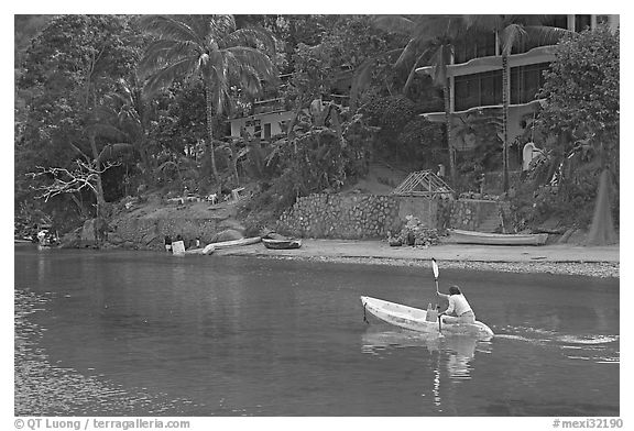 Woman using a canoe in a village,  Boca de Tomatlan, Jalisco. Jalisco, Mexico (black and white)