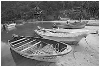 Small boats beached in a lagoon in fishing village, Boca de Tomatlan, Jalisco. Jalisco, Mexico (black and white)