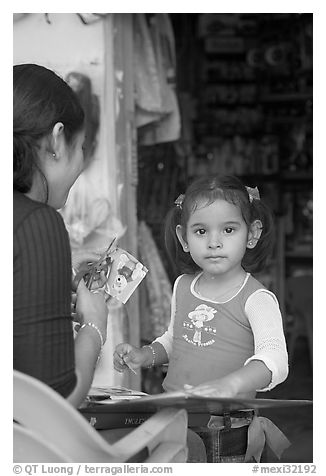 Girl playing with collages,  Boca de Tomatlan, Jalisco. Jalisco, Mexico (black and white)