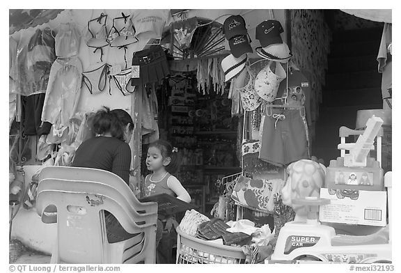 Woman and girl outside a store,  Boca de Tomatlan, Jalisco. Jalisco, Mexico