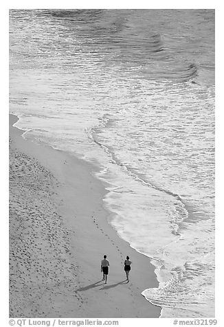 Couple walking on the beach seen from above, Puerto Vallarta, Jalisco. Jalisco, Mexico (black and white)
