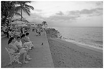 Women sitting on a bench looking at the ocean, Puerto Vallarta, Jalisco. Jalisco, Mexico (black and white)