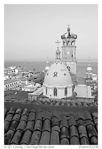 Red tile roof, Templo de Guadalupe Cathedral, and ocean early morning, Puerto Vallarta, Jalisco. Jalisco, Mexico