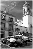 Policemen riding in the back of a pick-up truck. Zacatecas, Mexico (black and white)