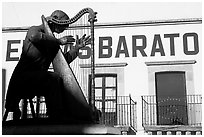 Statue of a musician and house with inscriptions. Zacatecas, Mexico ( black and white)